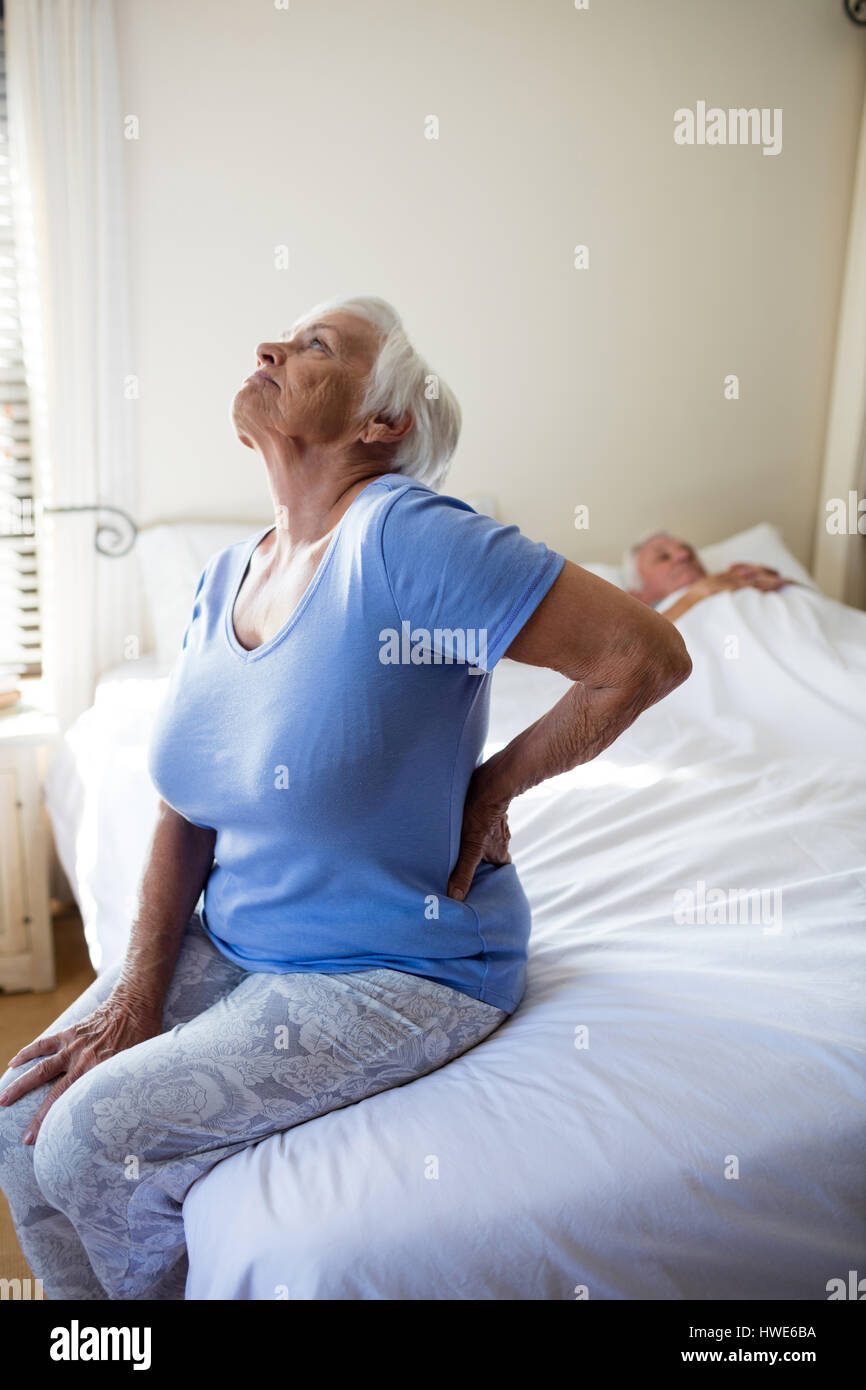 Senior woman suffering from backache in the bedroom at home Stock Photo ...