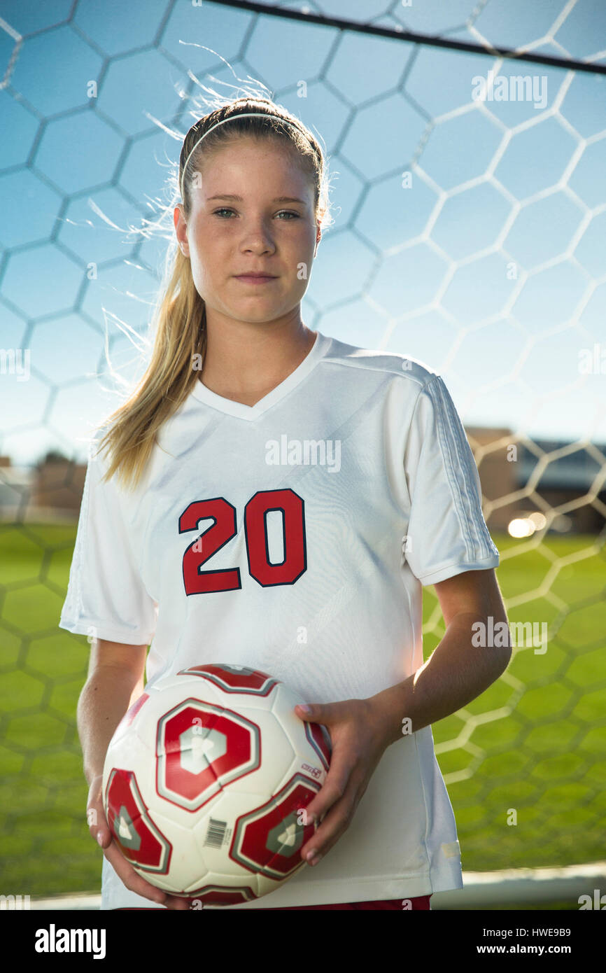 Proud goalie holding soccer ball in goal on sunny day Stock Photo Alamy