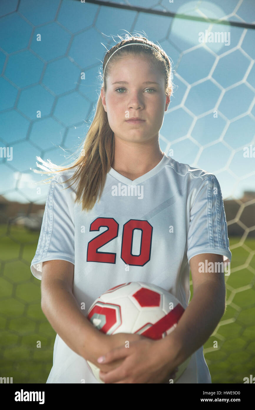 Proud goalie holding soccer ball in goal on sunny day Stock Photo Alamy