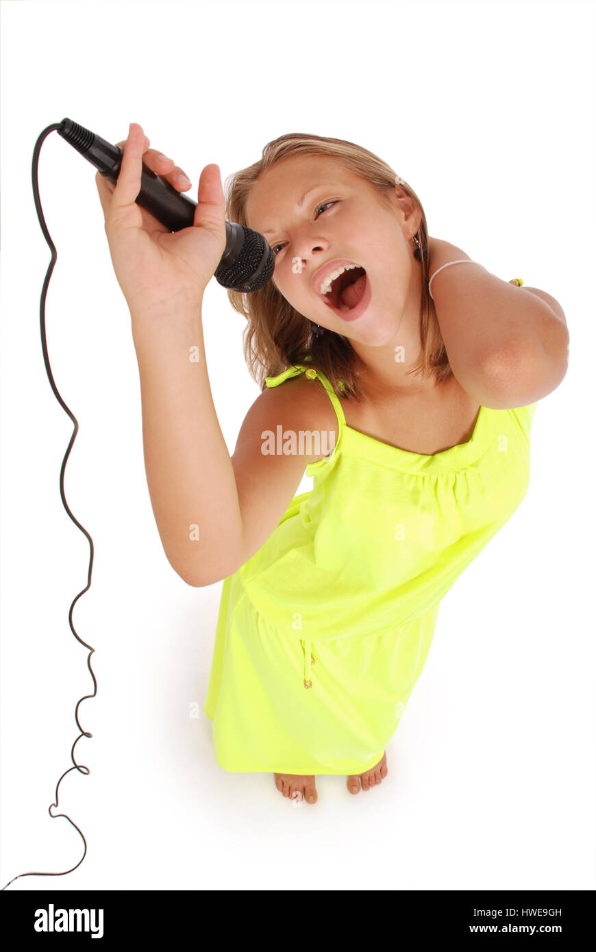 Happy young beautiful girl singing with microphone isolated on white