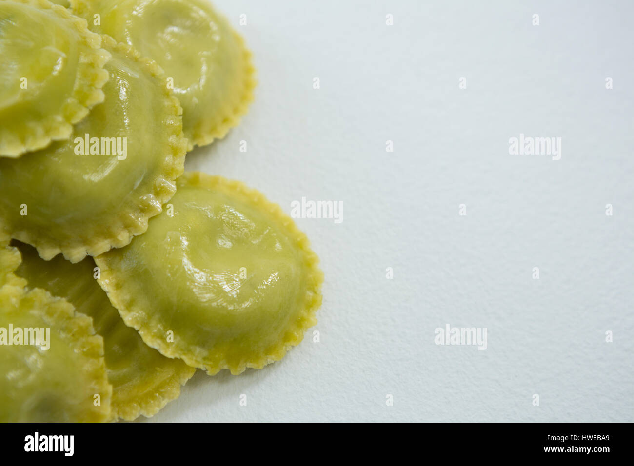 Close-up of round ravioli pasta on white background Stock Photo - Alamy