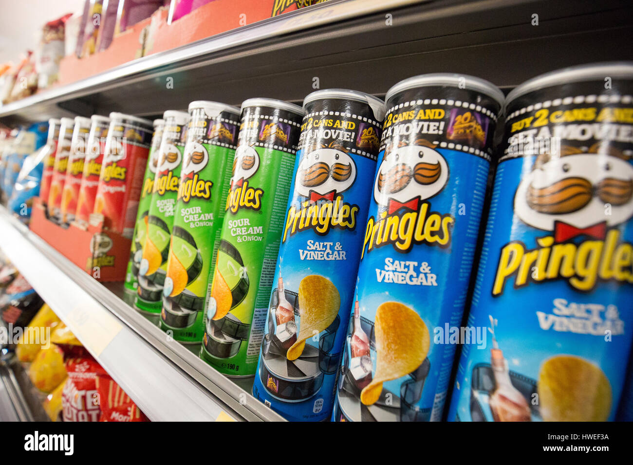 Tubes of Pringles crisps on a supermarket shelf Stock Photo