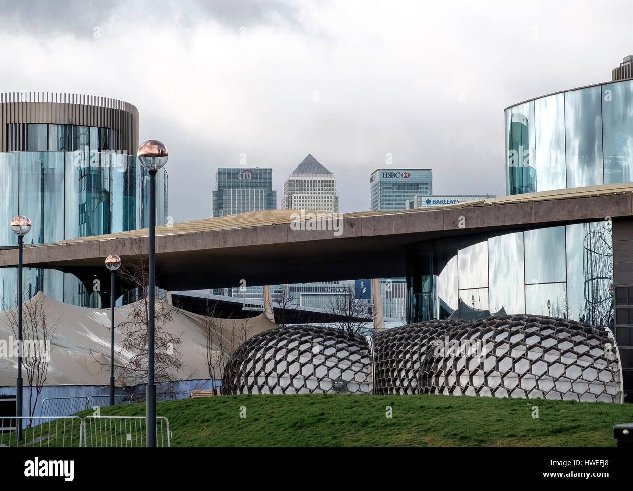 View through North Greenwich architecture towards Canary Wharf towers Stock Photo