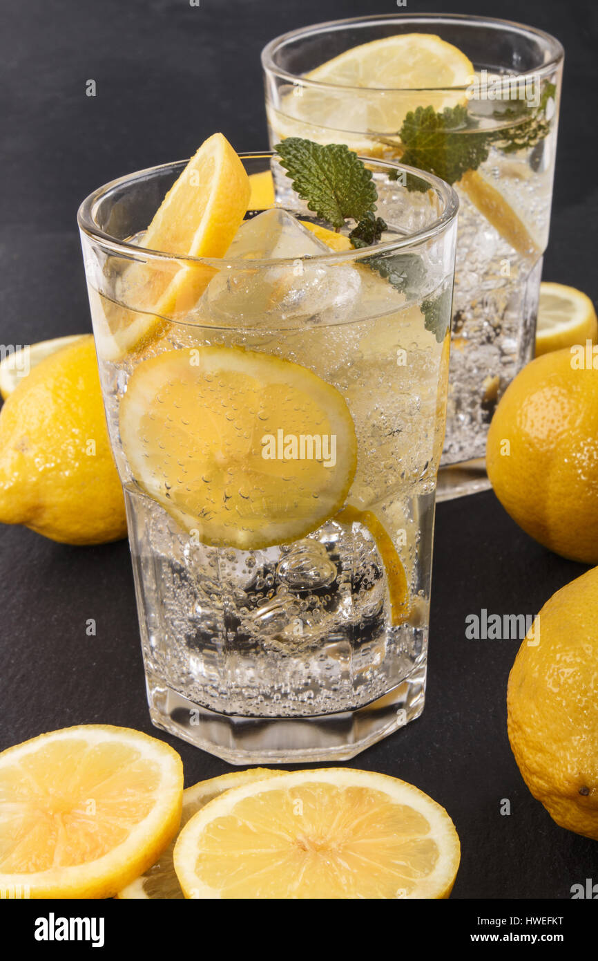 sparkling mineral water with ice and lemon slices in a glass Stock ...