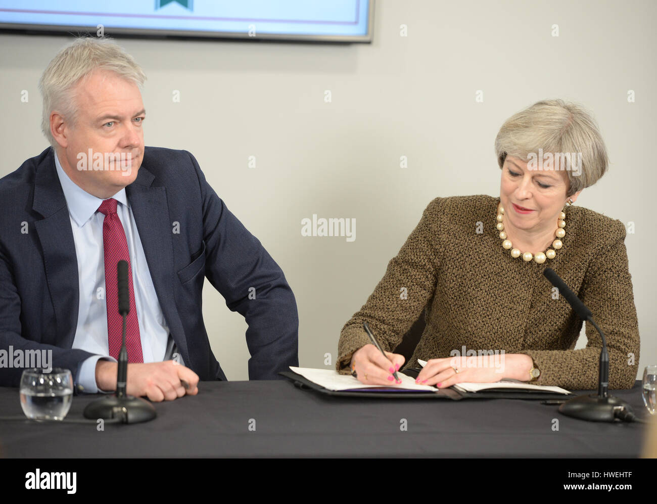 Prime Minister Theresa May (right) and First Minister Carwyn Jones sign a Swansea City deal during a meeting at the Liberty Stadium in Swansea, as she faces pressure to keep the union together in the wake of the divisive Brexit vote. Stock Photo