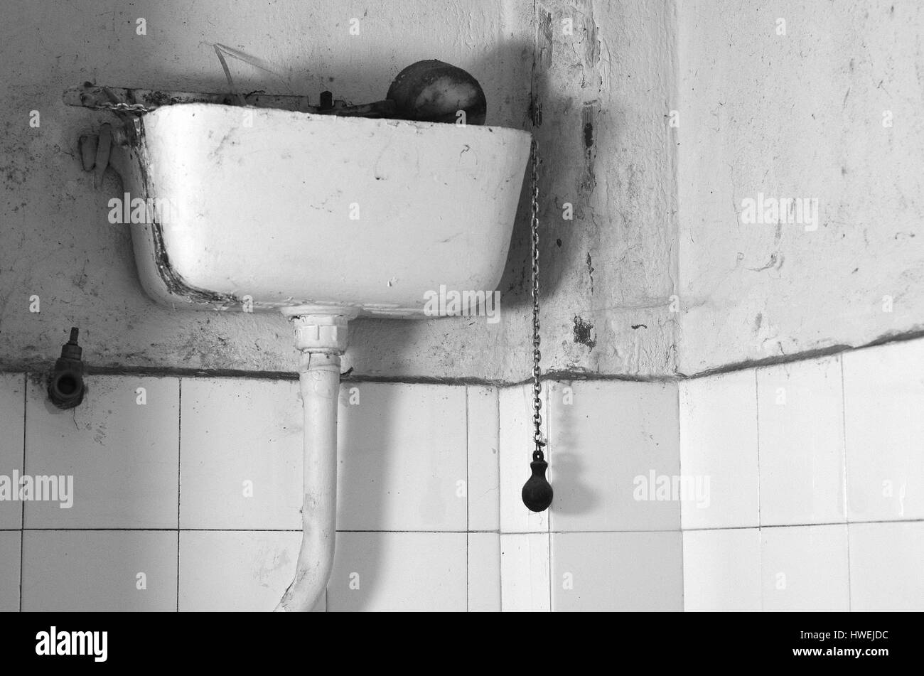 Dirty old flush toilet mechanism black and white theme Stock Photo