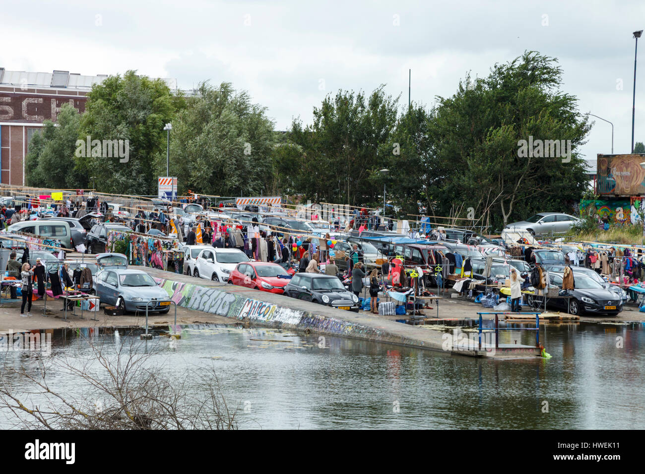 Cars and stalls pack the IJ Hallen fleamarket on the NDSM wharf in Amsterdam Stock Photo