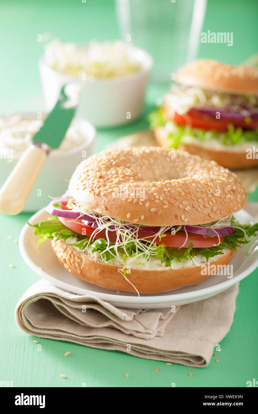 tomato sandwich on bagel with cream cheese onion lettuce alfalfa sprouts Stock Photo