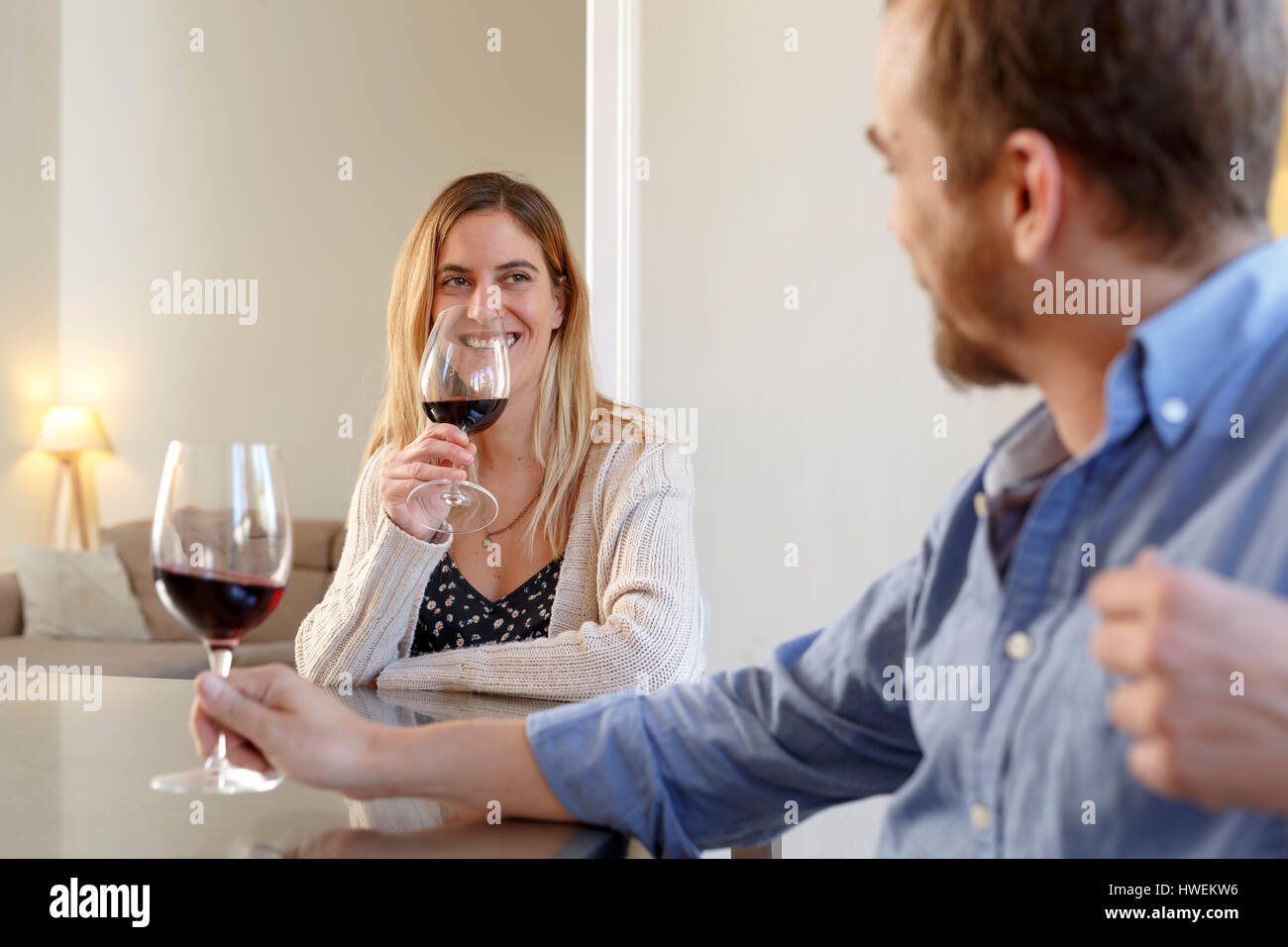 Mid adult couple at home, relaxing, having glass of wine Stock Photo ...