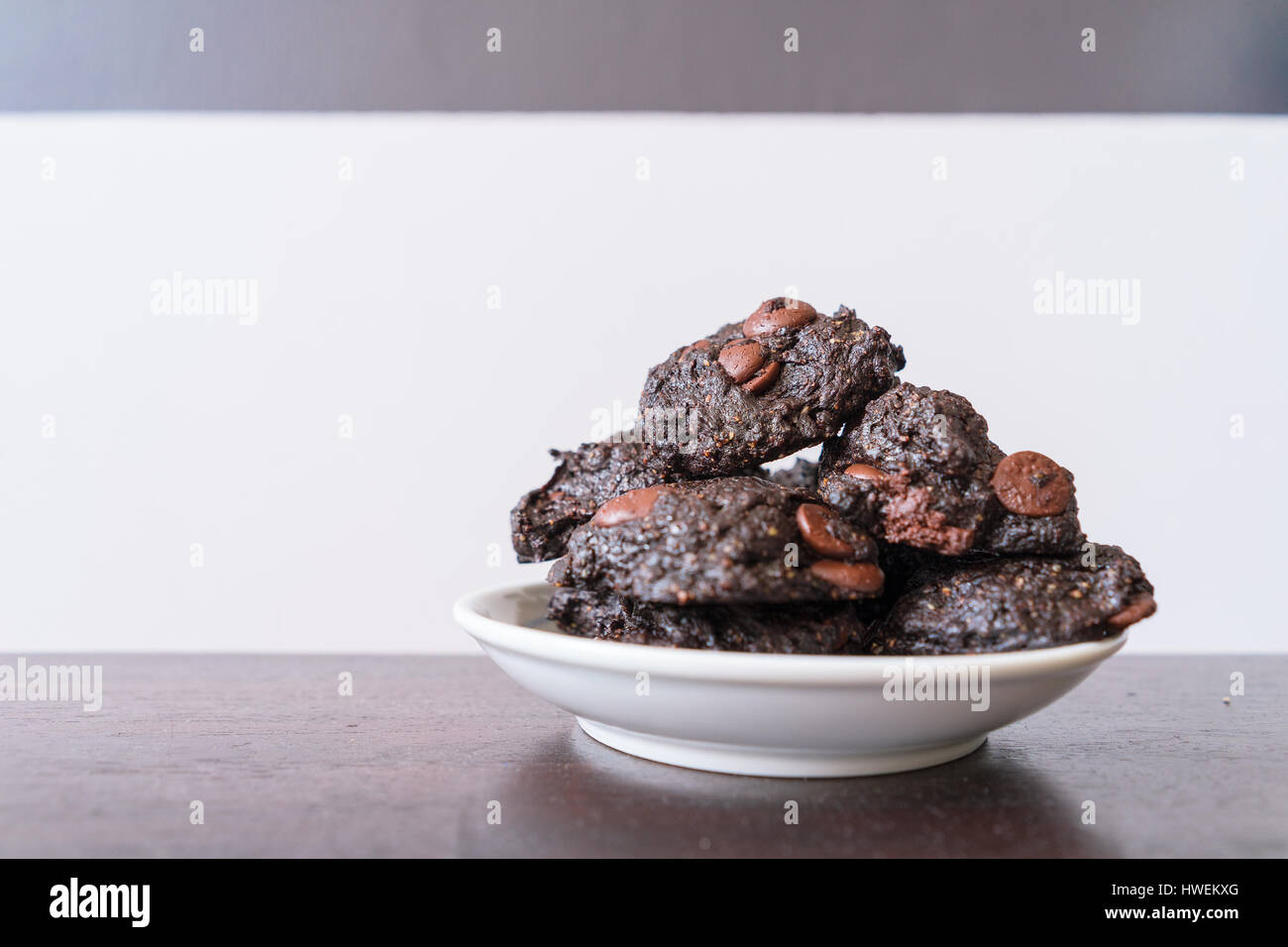Stack of Vegan chocolate brownie cookie on white round plate Stock