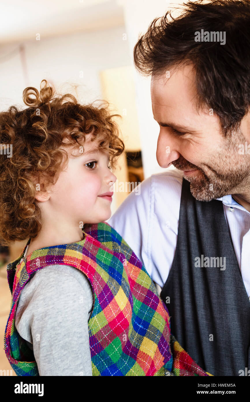 Loving man carrying daughter in arms Stock Photo