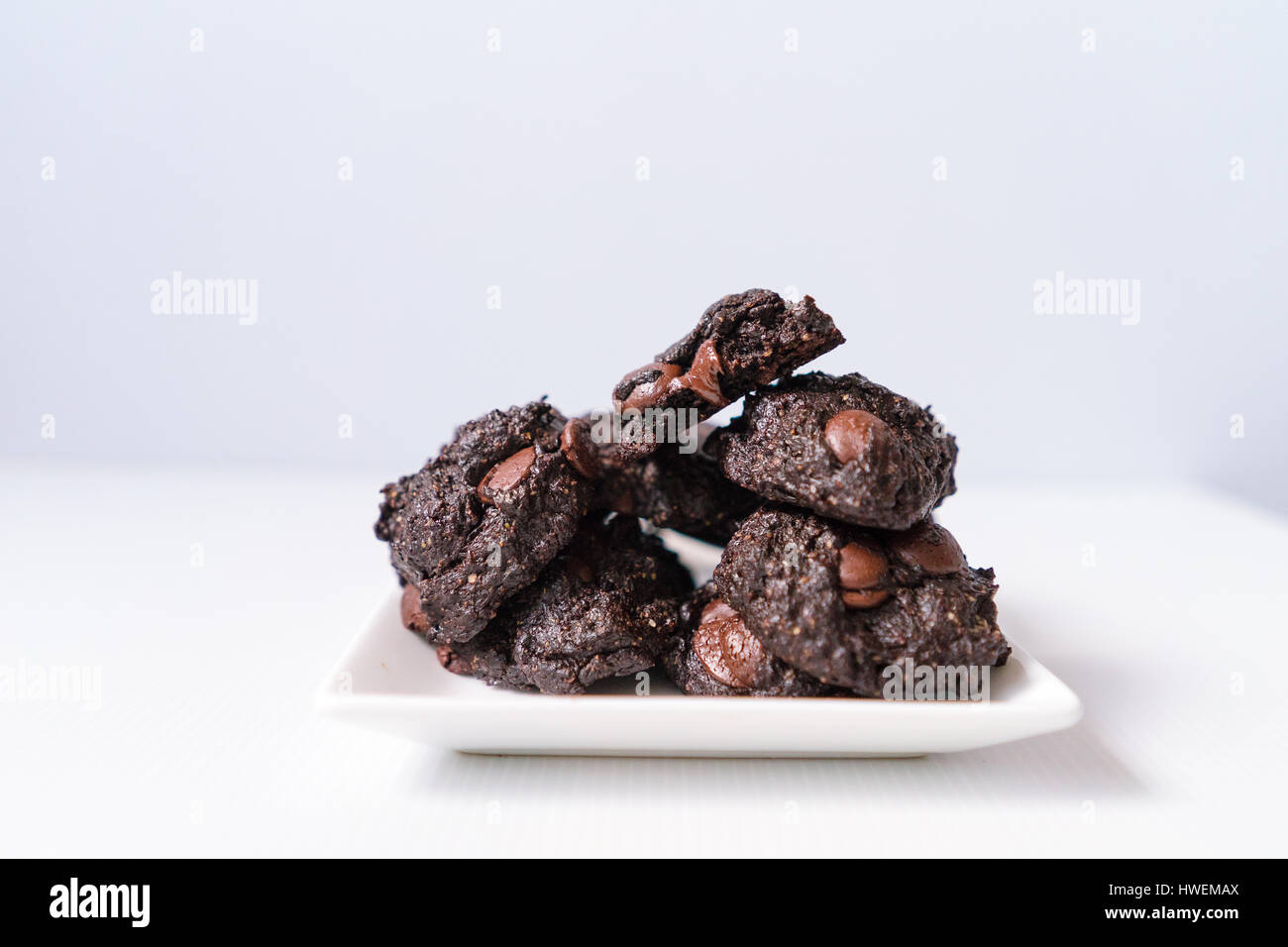 Stack of Vegan chocolate brownie cookie on white square plate Stock