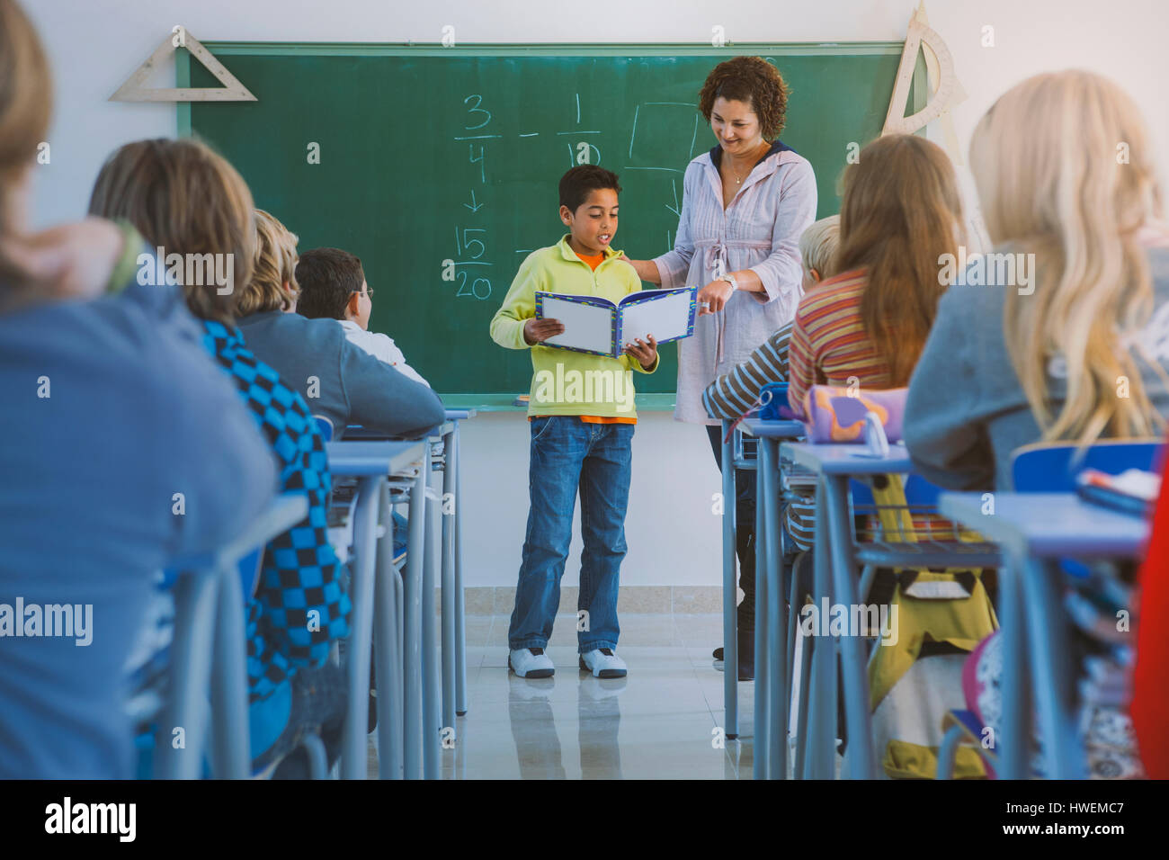 Boy standing front class reading hi-res stock photography and images