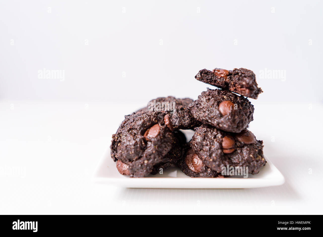 Stack of Vegan chocolate brownie cookie on white square plate Stock