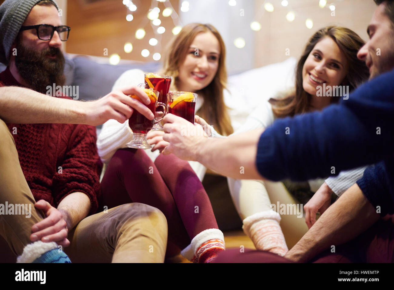 Friends enjoying mulled wine in chalet Stock Photo