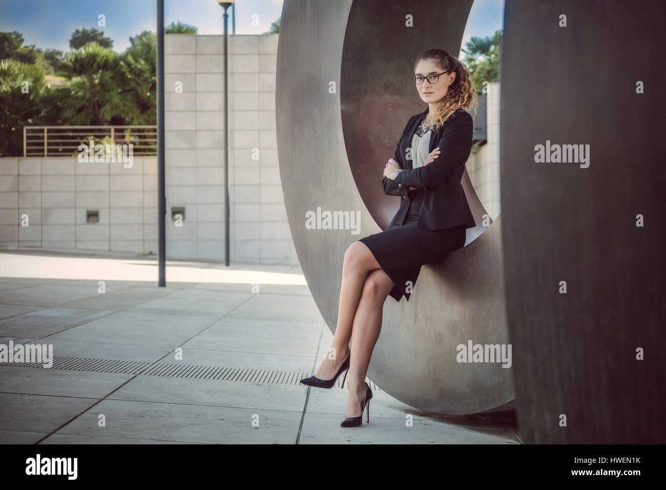 Girl sitting arms legs crossed hi-res stock photography and images - Alamy