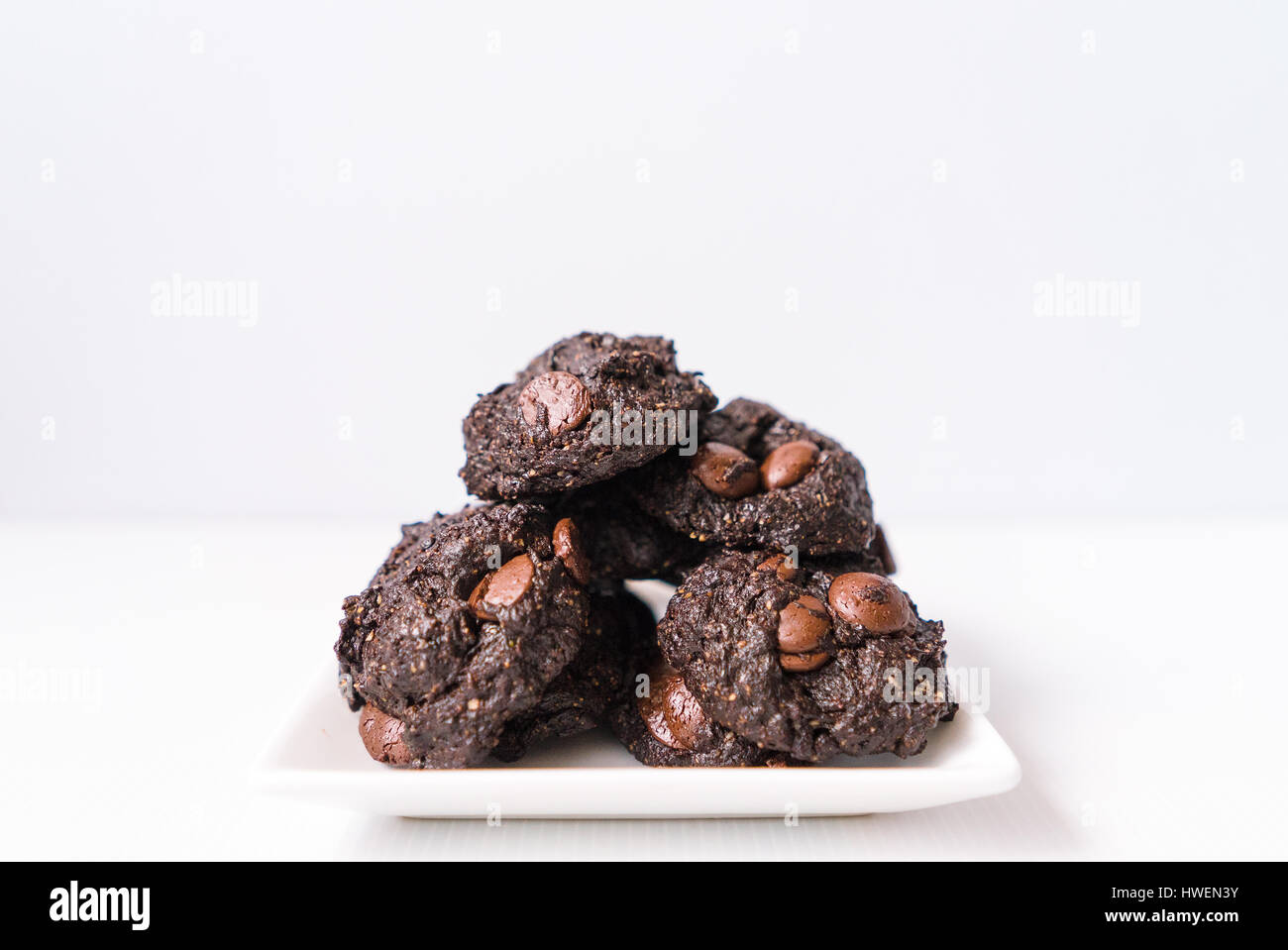 Stack of Vegan chocolate brownie cookie on white square plate Stock