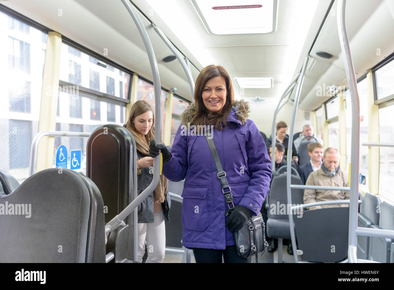 Passenger travelling on electric bus Stock Photo