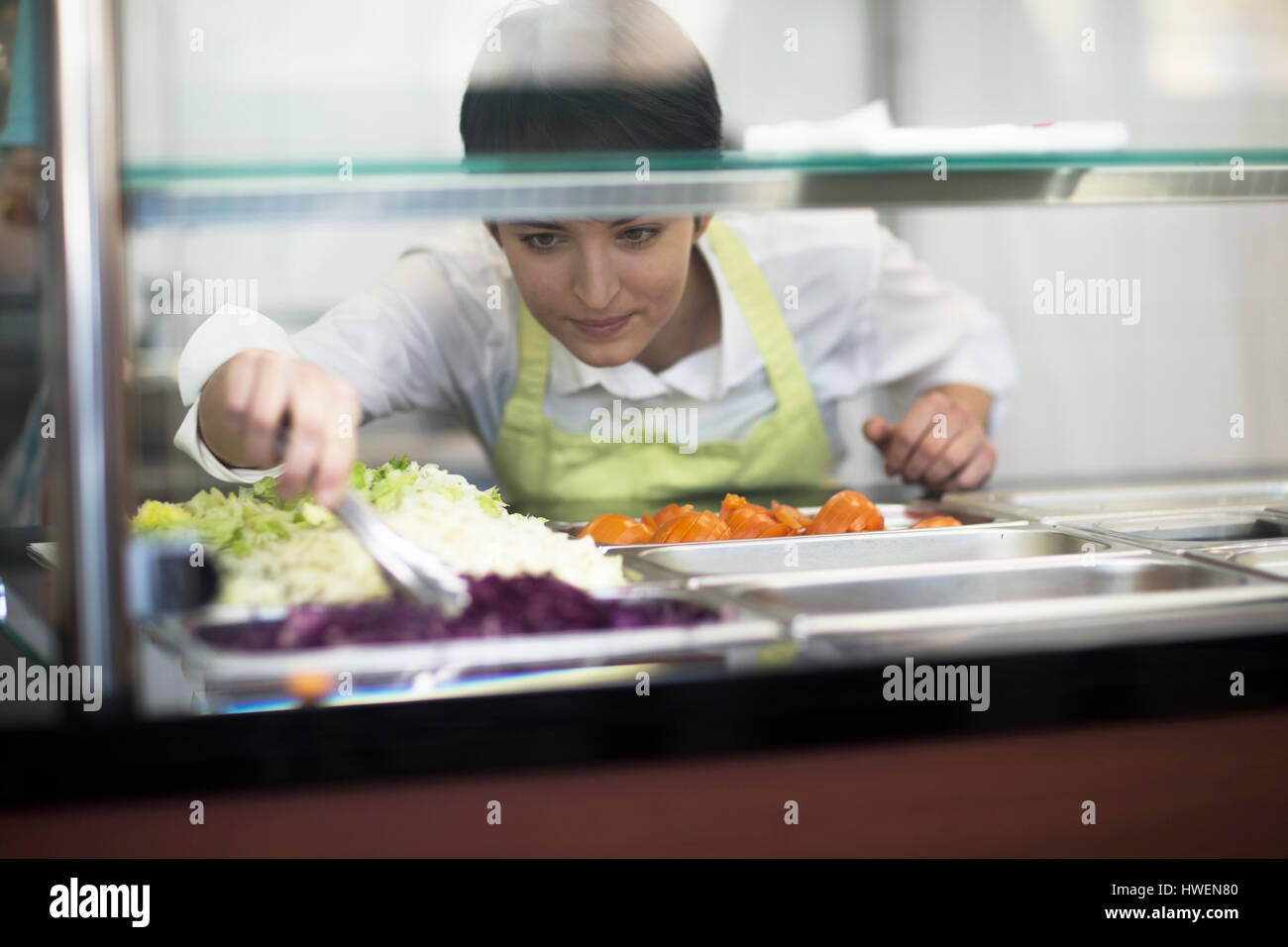 Young woman preparing food in fast food shop Stock Photo Alamy