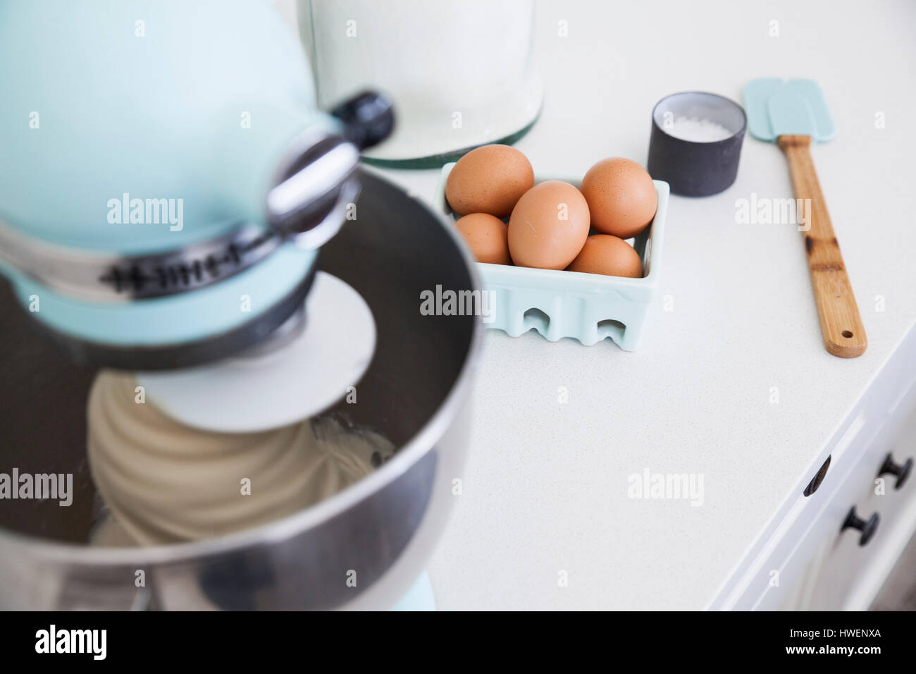 Food mixer mixing cake on kitchen counter Stock Photo