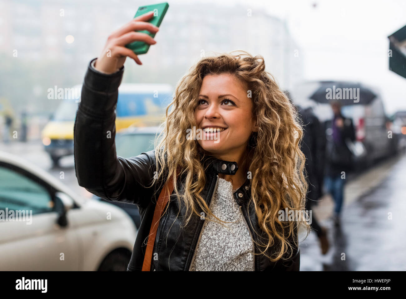 Woman taking selfie on street hi-res stock photography and images - Alamy