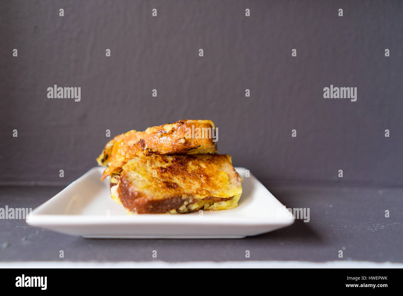 French Toast Breakfast in grey background, white plate Stock Photo