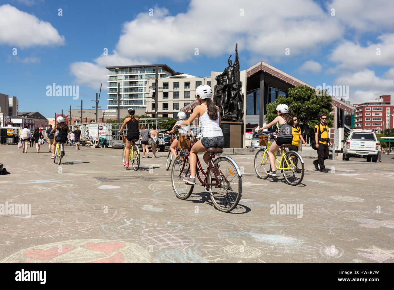 WELLINGTON, NEW ZEALAND - MARCH 2, 2017: Yound girls ride biclycles on the Wellington waterfront promenade on a sunny summer day in New Zealand capita Stock Photo