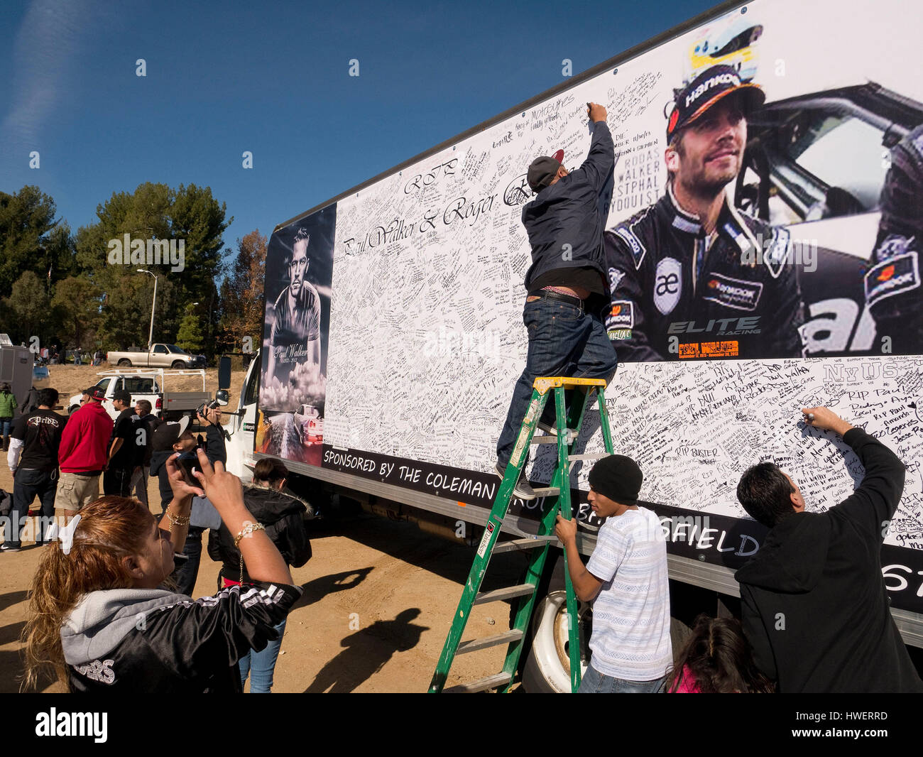 Fans sign a billboard near a make shift memorial for actor Paul Walker, star  of the 