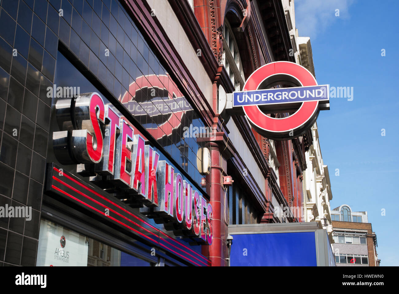 Colourful London signs. Steak houses and underground sign. London, UK Stock Photo