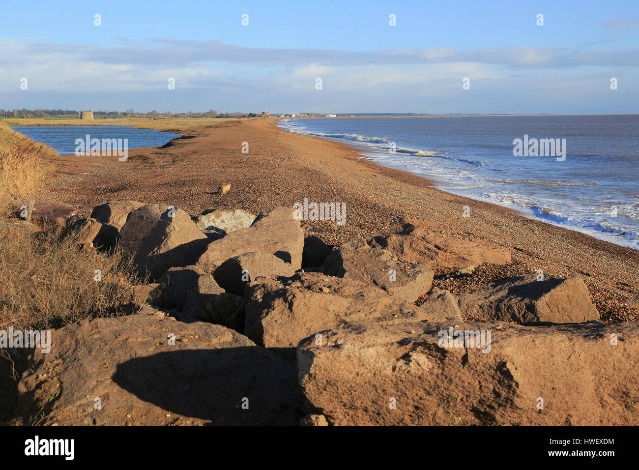 Shingle bay bar and lagoon formed by longshore drift, view north from Bawdsey to Shingle Street, Suffolk, England, UK Stock Photo