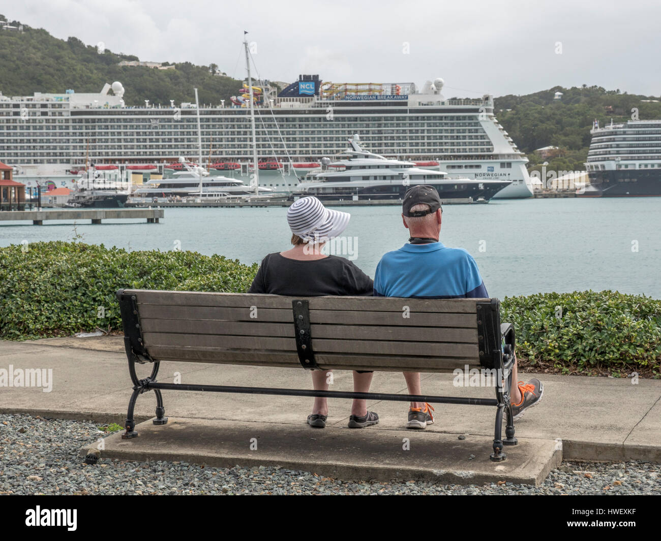 A Retired Couple On Their Way Back To The Cruise Ship Sit Down For A Rest At Yacht Haven Grande, Charlotte Amalie, St Thomas USVI Stock Photo
