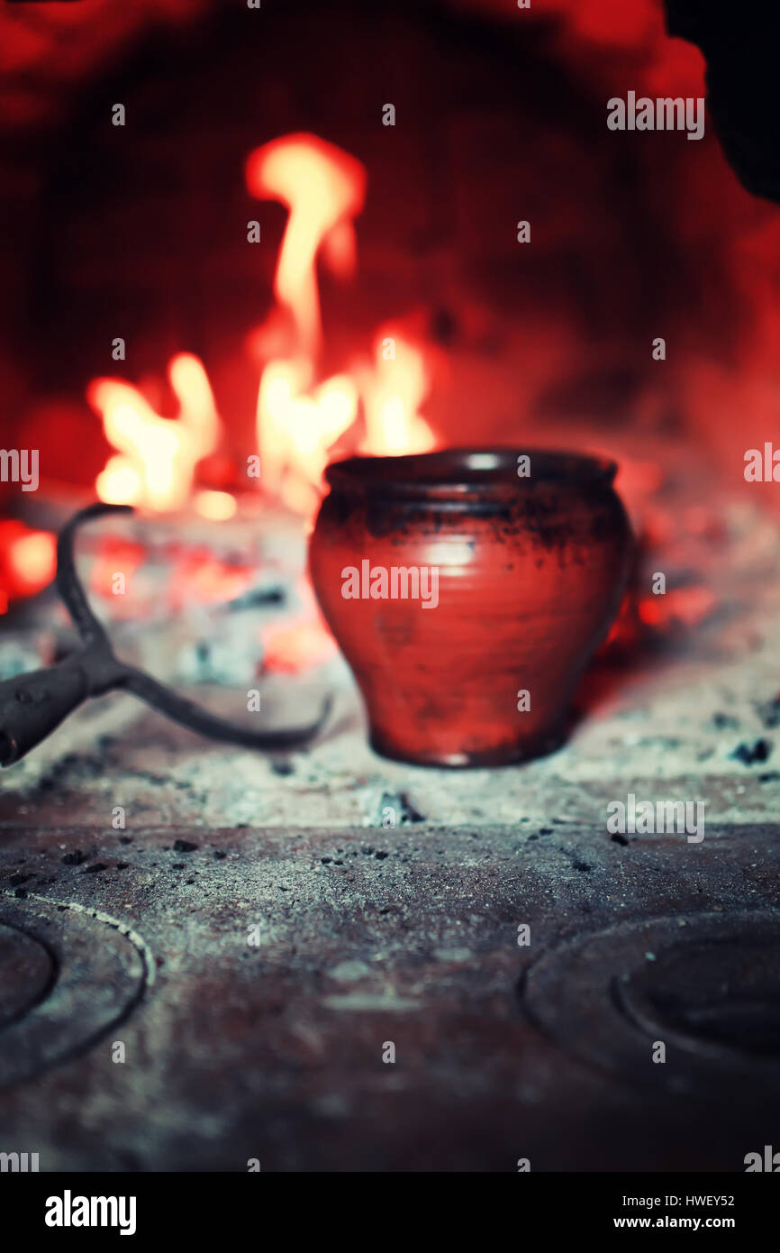 pot in the oven and oven fork Stock Photo Alamy