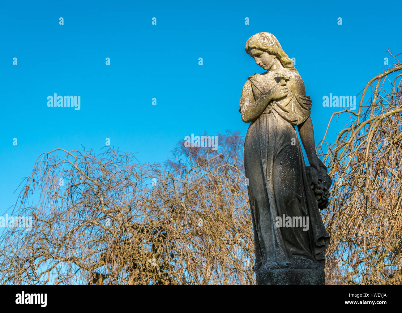 Graceful stone statue of sad thoughtful woman in churchyard, St Mary’s Parish Church, Haddington, East Lothian, Scotland, UK Stock Photo