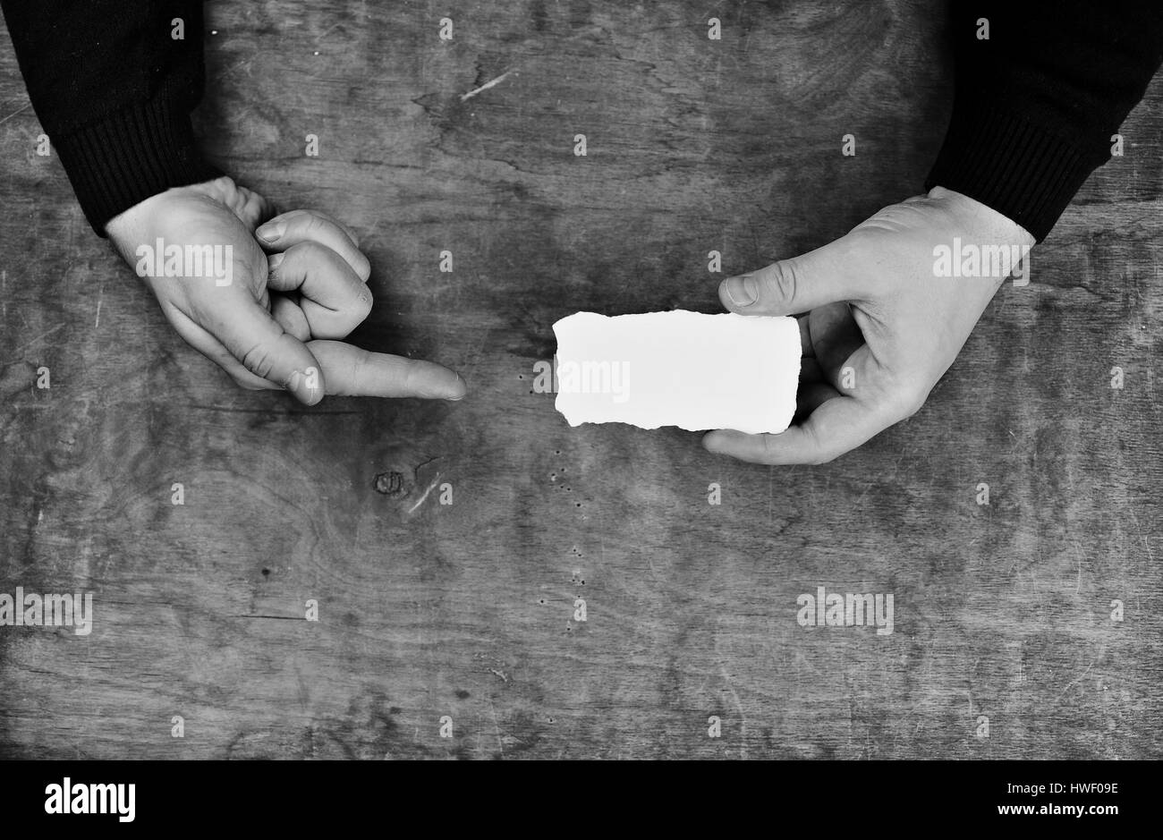 monochrome photo male hands holding a white blank sheet of paper Stock ...