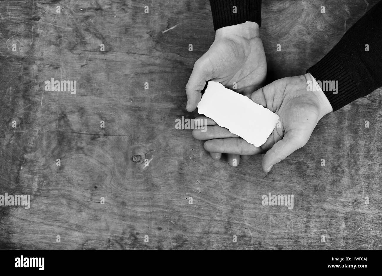 monochrome photo male hands holding a white blank sheet of paper Stock ...