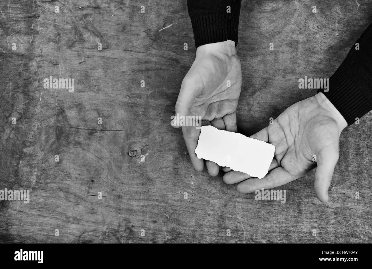 monochrome photo male hands holding a white blank sheet of paper Stock ...
