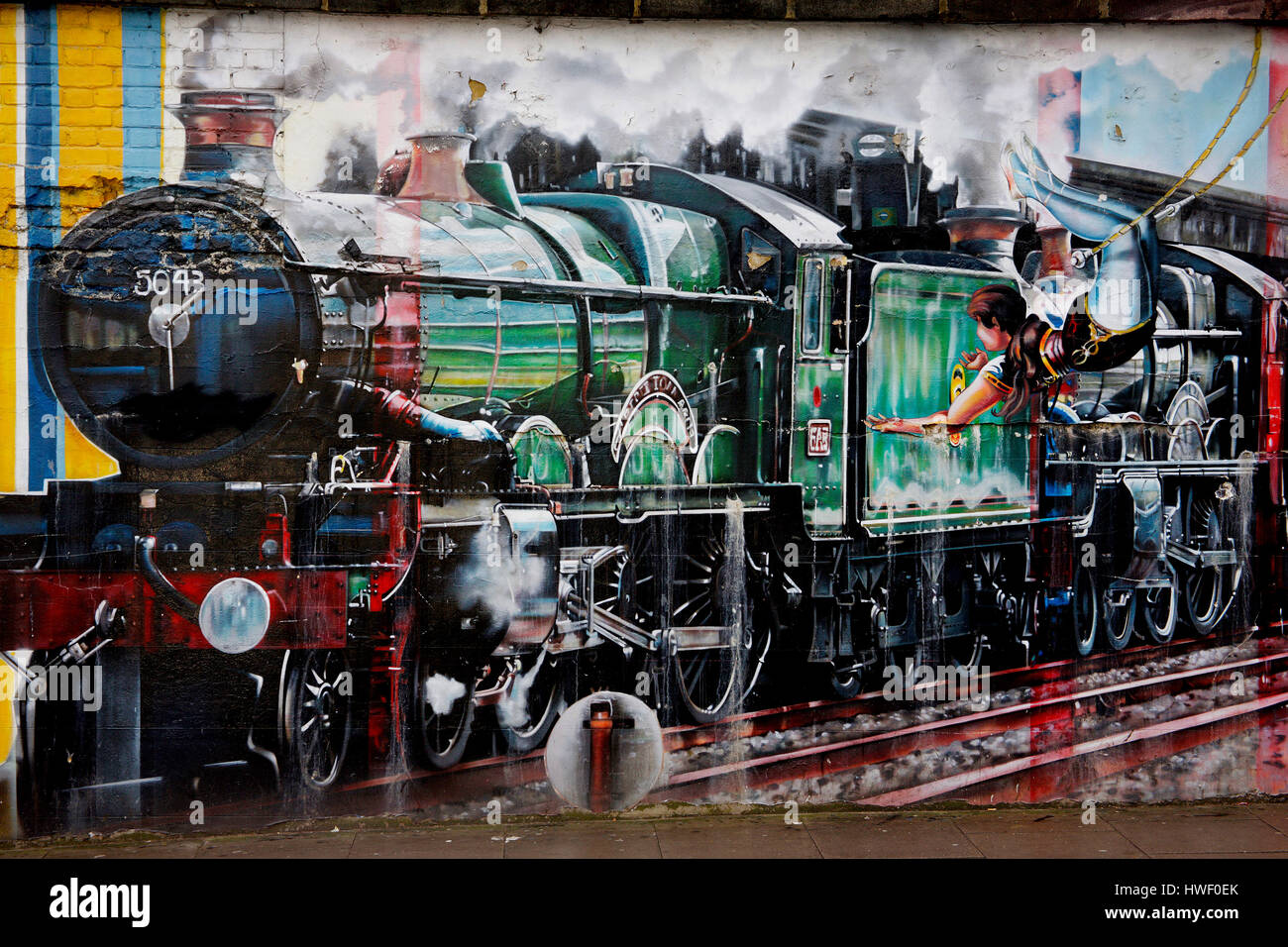 mix of graffiti images by Kobra portraying various artistic endeavors, including, acrobats and a boy reaching out to a stream train, Stock Photo