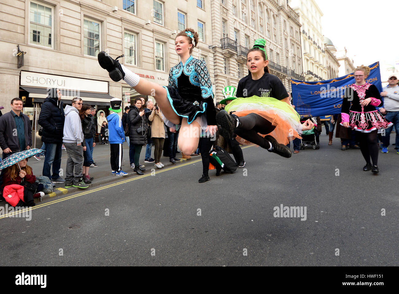 Irish Dancers of Drumenagh School at the 2017 St. Patrick's Day Parade in London, UK. Young female dancers leaping Stock Photo