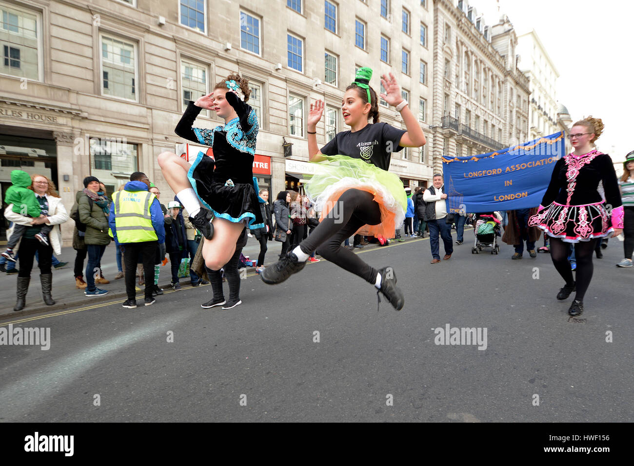 Irish Dancers of Drumenagh School at the 2017 St. Patrick's Day Parade in London, UK. Young female dancers leaping Stock Photo