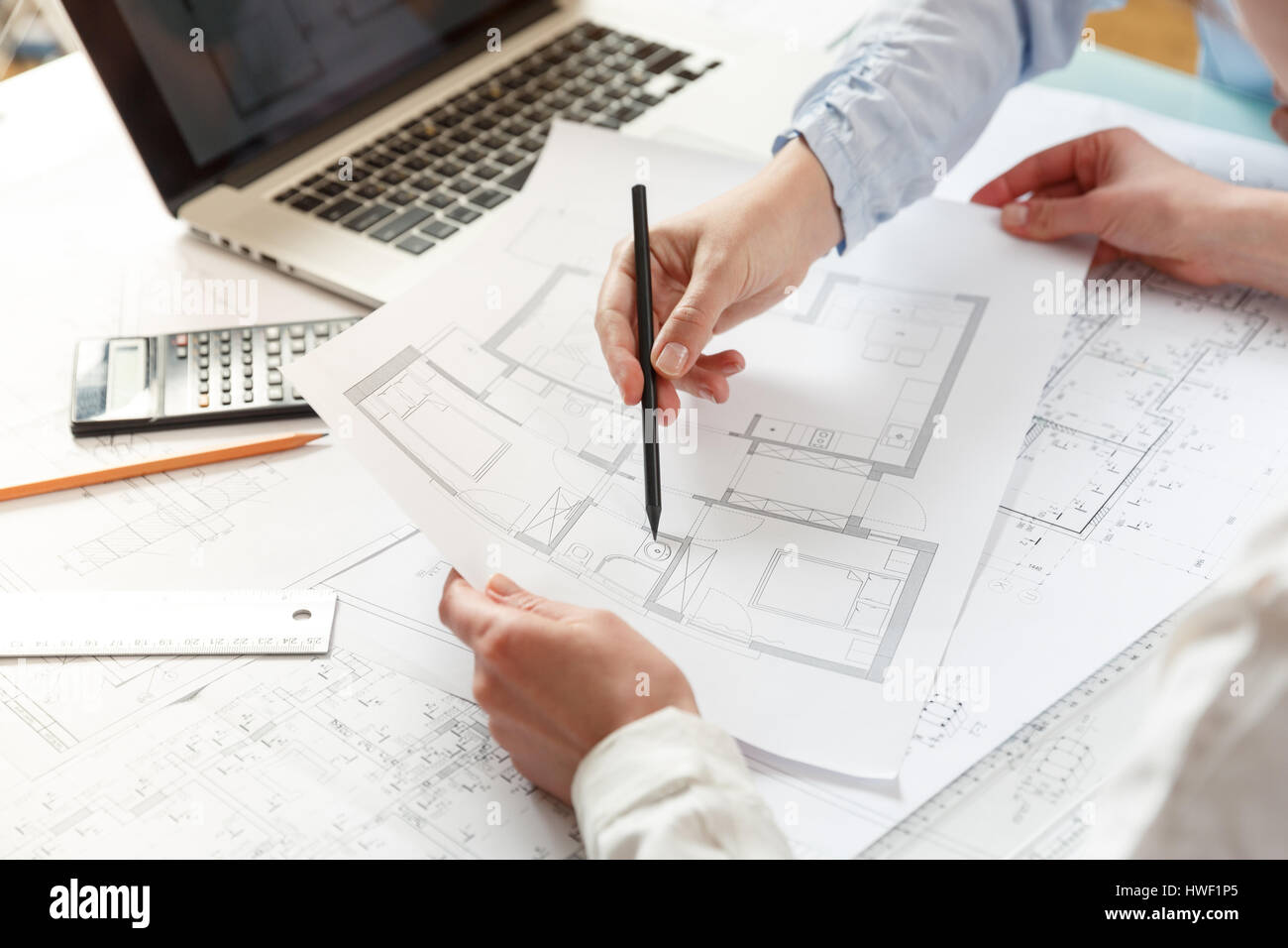 Young female architect and designer working on blueprint project of ... Young female architect and designer working on blueprint project of ...