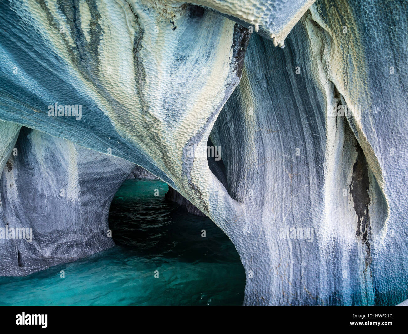 Inside the marble caves near Puerto Rio Tranquilo, small sightseeing boats explore single areas of the cave, Aysen region, Patagonia, Chile Stock Photo