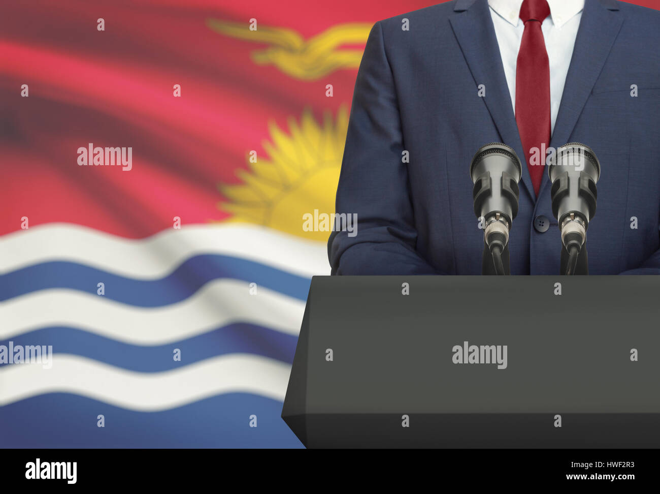 Businessman or politician making speech from behind the pulpit with national flag on background - Kiribati Stock Photo