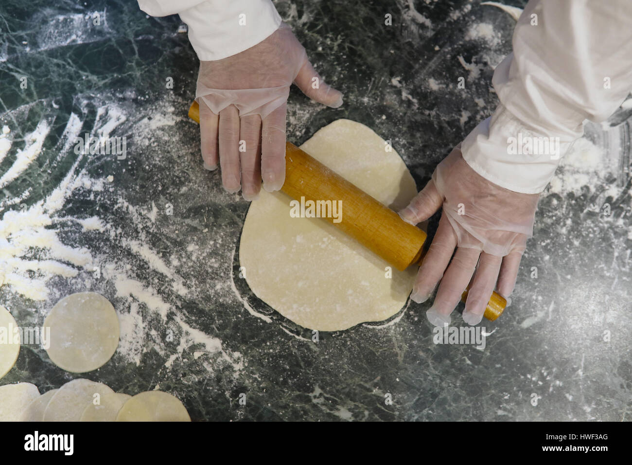 Male chef uses ingredients for preparing flour products on kitch Stock ...