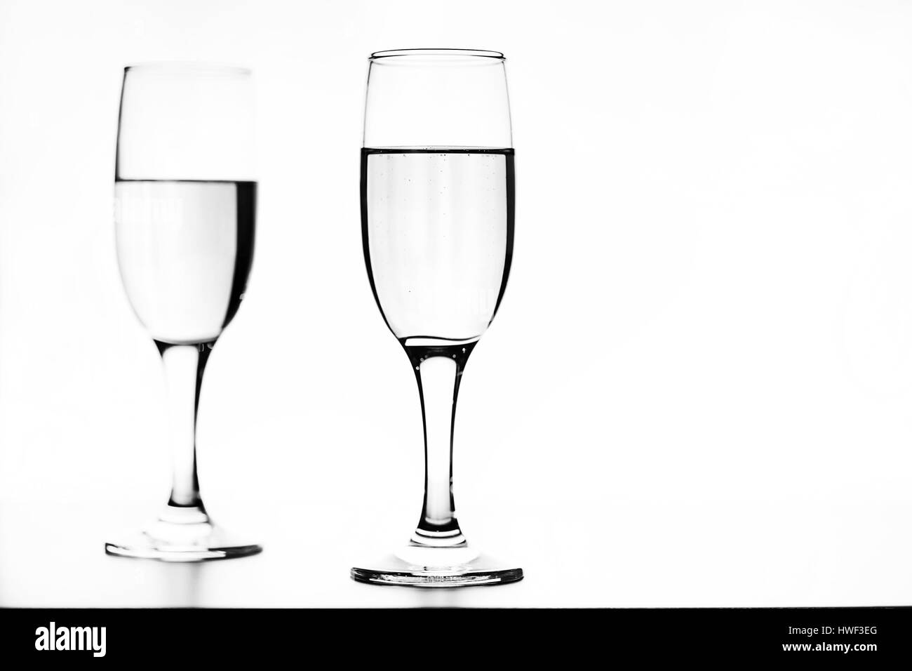 monochrome photo of champagne on white table on white background Stock