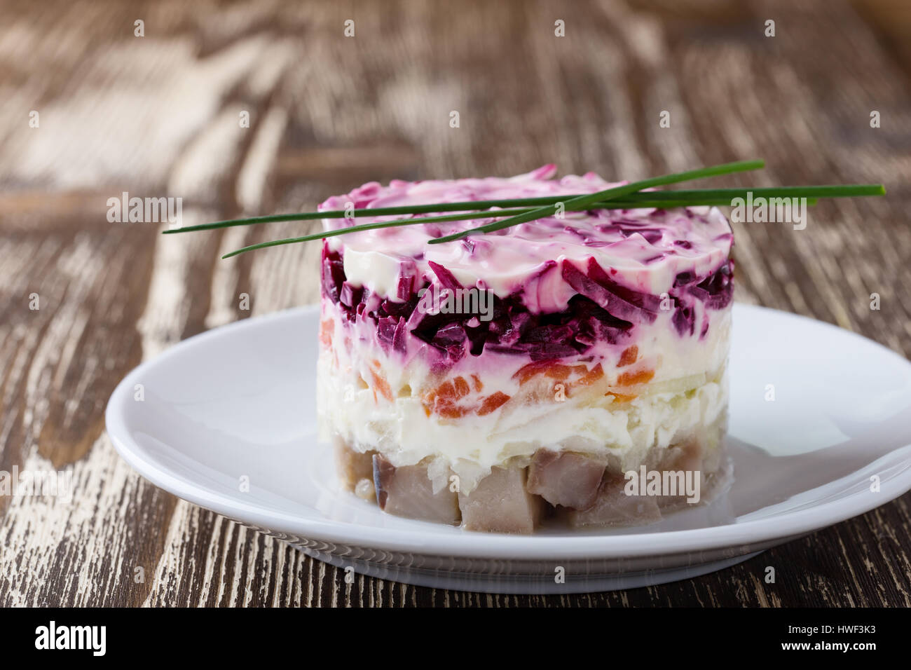 Homemade dressed pickled herring, traditional russian layered salad