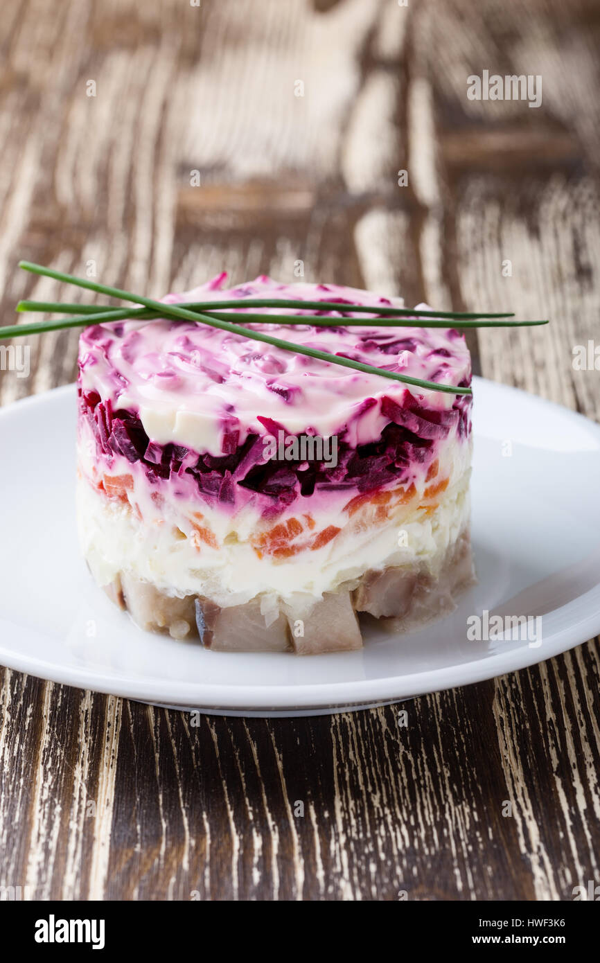 Homemade dressed pickled herring, traditional russian layered salad