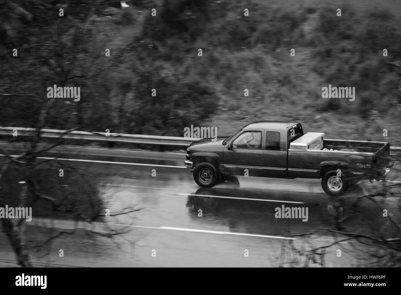 San Diego 27 Feb, 2017. beautiful rainy day in La Mesa, car going fast on a road full of water. Stock Photo