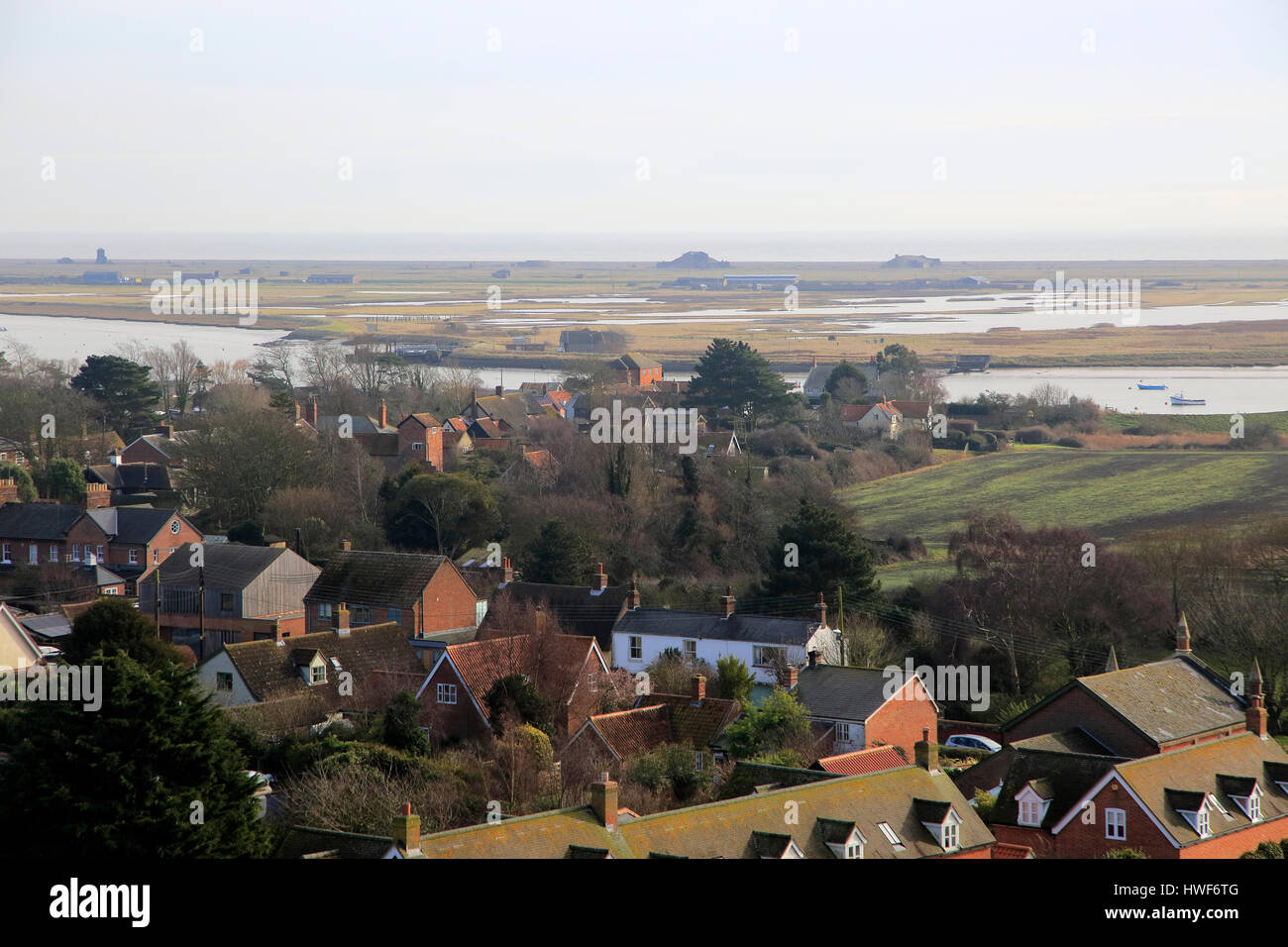 Orford Ness shingle spit view over rooftops of village houses, Orford