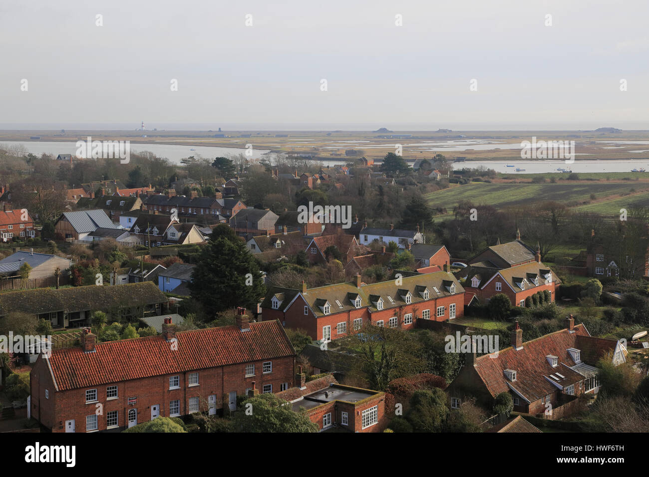 Orford Ness shingle spit view over rooftops of village houses, Orford