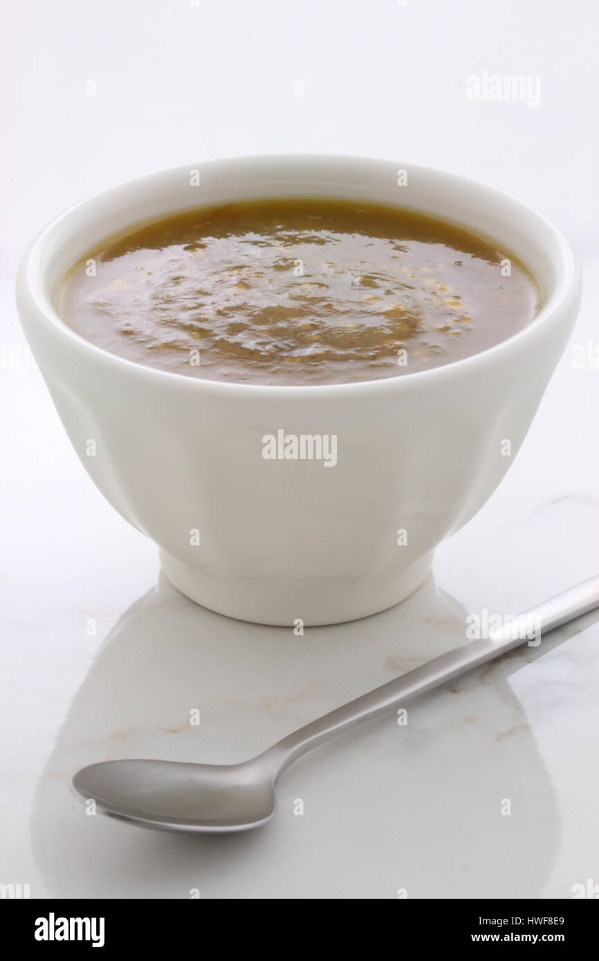 Artisan mexican tomatillo sauce on vintage carrara marble table, with a